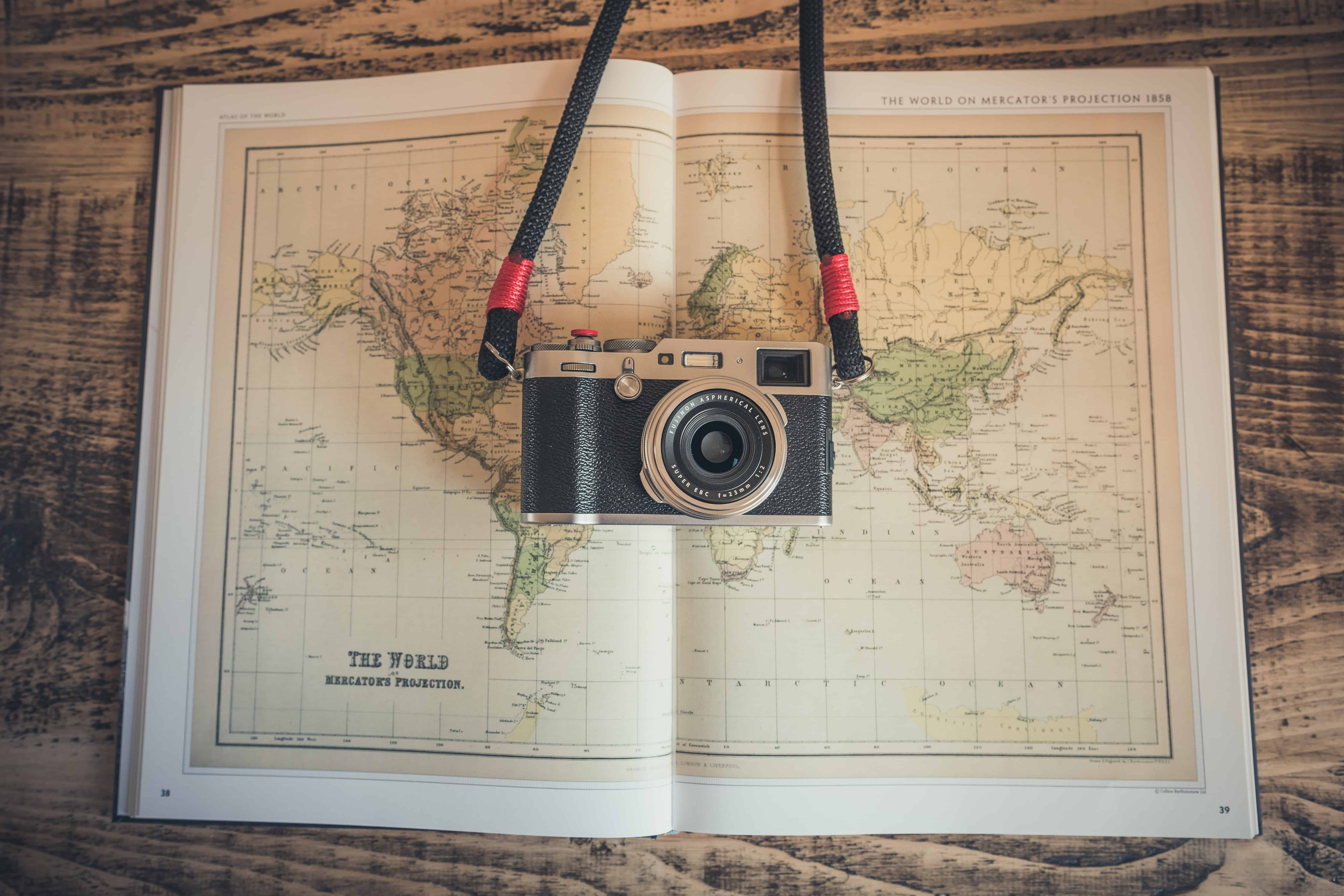 camera on top of a world map book